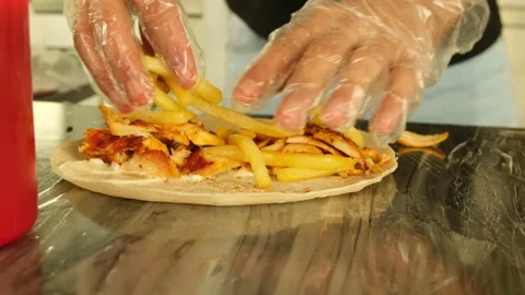 Putting fries on Shawarma Stock Footage 145789616