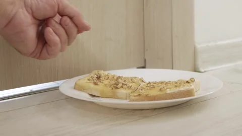 Putting in Front of the Door a Plate with Toast Spread, Butter, Cheese, Honey Stock Footage 336916998