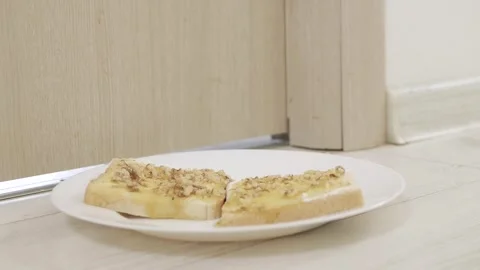Putting in Front of the Door a Plate with Toast Spread, Butter, Cheese, Honey Stock Footage 340036238
