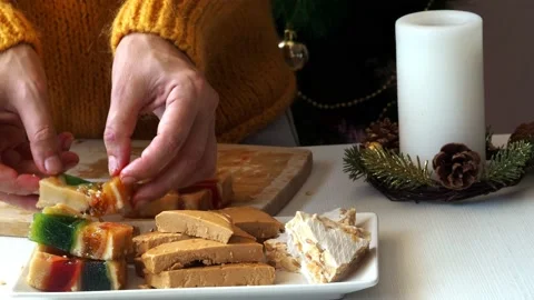 Putting fruit nougat on a plate Stock Footage 207864904