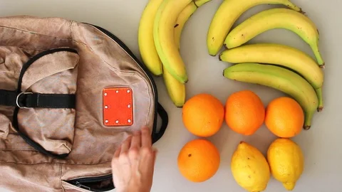 Putting  fruits into old backpack after grocery shopping Stock Footage 105585759