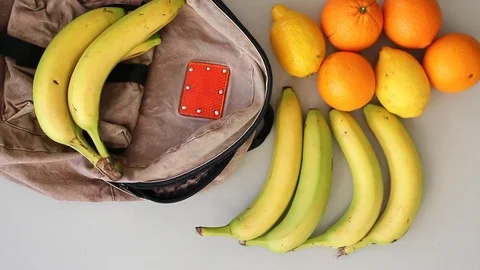 Putting fruits into old backpack after grocery shopping Stock Footage 105585941