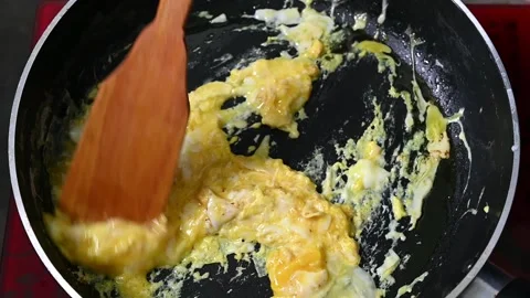 Putting frying pan with freshly fried eggs on table with served nourishing b Stock Footage 203476881