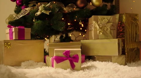 Putting Gift Box by Christmas Tree Stock Footage 57749248