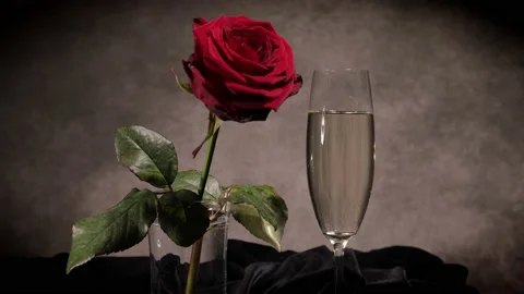 Putting a glass of Champagne on a table Stock Footage 151125486