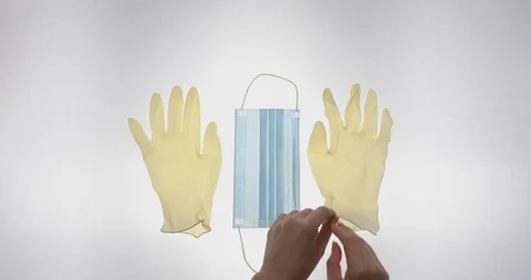 Putting on gloves and mask Stock Footage 128597922