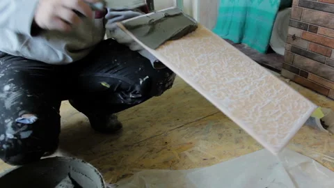 Putting glue solution on the tile Stock Footage 116386801