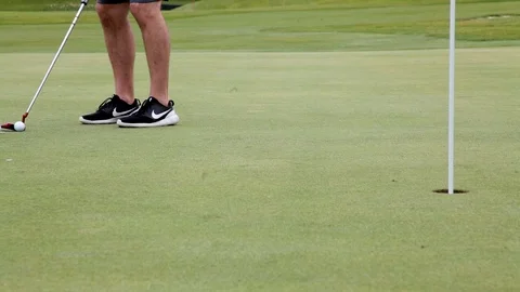 Putting a golf ball on a green Stock Footage 124825718