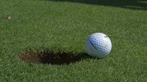 Putting Golf Ball into Hole Stock-Footage 118027628