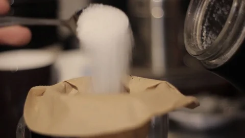 Putting Granulated Sugar Into a Coffee Filter Stock Footage 85992312