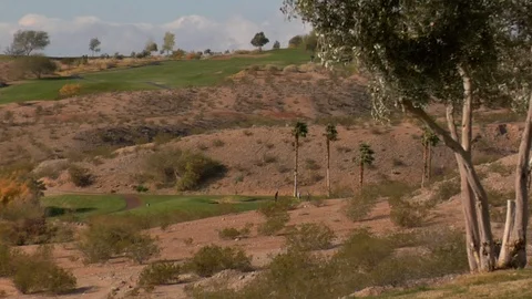 Putting green golf course surrounded by desert land D Stock Footage 125344716
