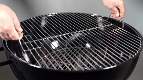 Putting grid on the Charcoal grill Stock Footage 145844962