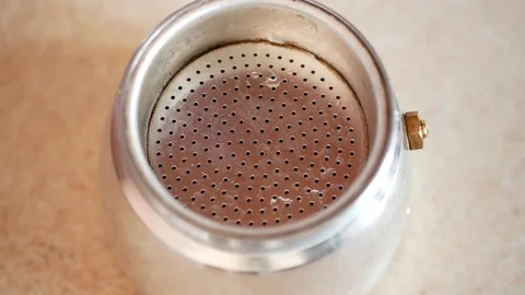 Putting ground coffee into the moka pot coffee maker. Stock Footage 70399992