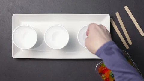 Putting Gummy Bears In Styrofoam Cups Stock Footage 87842766