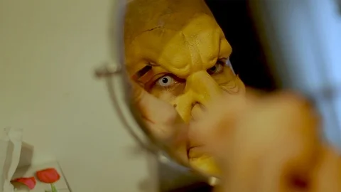 Putting on Halloween make up and prosthetic. Adult witch costume FX make up. Stock Footage 97668577
