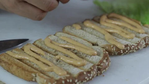 Putting ham on bread to make a sandwich 스톡 동영상 130061993