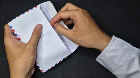 Putting handwritten letter into envelope Stock Footage 296261795