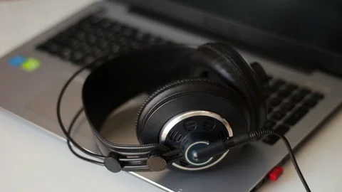 Putting headphones on the notebook Stock-Footage 76999489