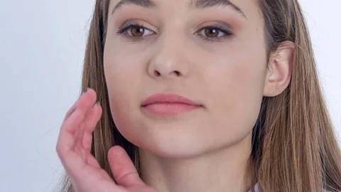 Putting her hand on her cheek Stock Footage 84135477