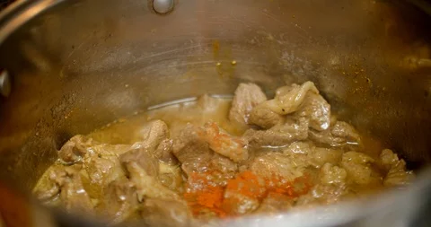 Putting hot pepper in the boiling meat in a saucepan Stock Footage 88048613
