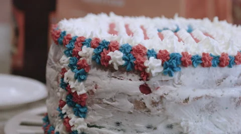 Putting icing on a red white and blue cake Stock Footage 64893515
