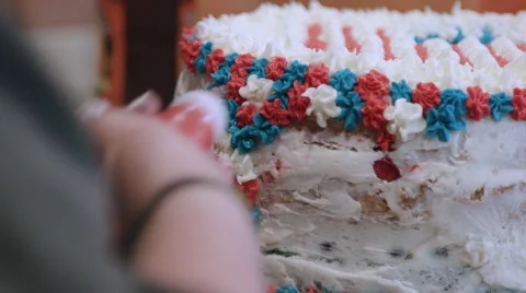 Putting icing on a red white and blue cake Stock Footage 64893645