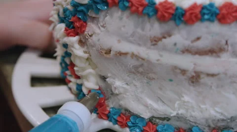 Putting icing on a red white and blue cake Video stock 64894618