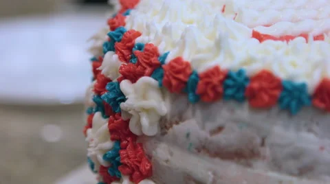 Putting icing on a red white and blue cake Stock-Footage 64894849