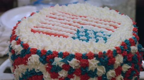 Putting icing on a red white and blue cake Stock Footage 64895375