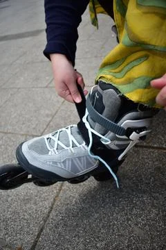 Putting on inline roller blades Stock Photos