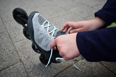 Putting on inline roller blades Stock Photos
