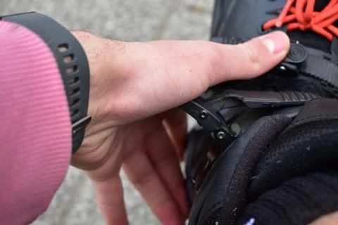 Putting on inline roller blades Stock Photos