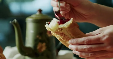 Putting jam on bread, close-up 4K. Video stock 221570833