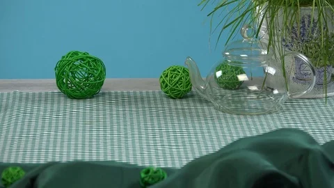 Putting a jar with tea on a table with a teapot Video stock 79873397