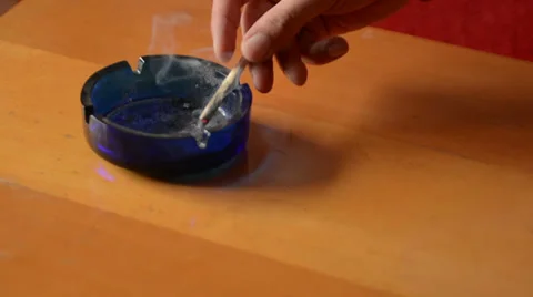 Putting joint in ashtray then tracking Stock Footage 37798482