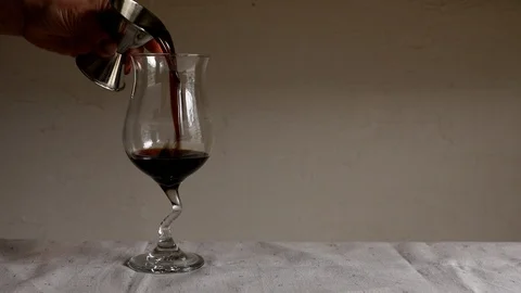 Putting Kahlua and ice into glass cup to make Kahlua milk Stock Footage 105628621
