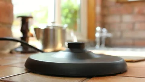 Putting kettle on Stock Footage 11242415