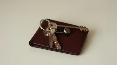 Putting keys on brown belt Видео 75827810