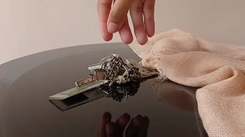 Putting the keys on the brown table Stock Footage 150397903