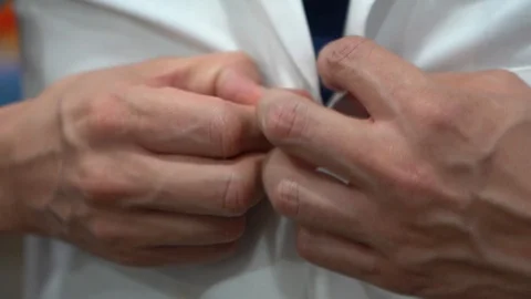 Putting lab coat on Stock Footage 107321639