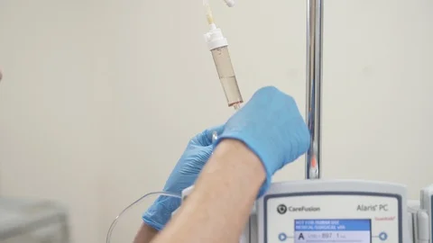 Putting label on IV line Stock Footage 125783249