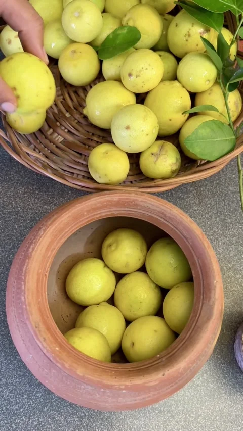 Putting lemon in a clay pot for making pickle. Stock Footage 287177460