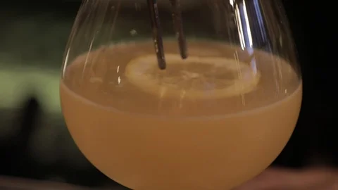 Putting Lemon Slice on Top of Cocktail Stock Footage 129832109