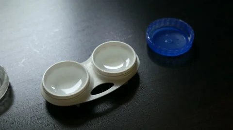 Putting the lens in the lens container Stock Footage 65807502