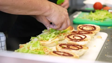 Putting lettuce on a burger Stock Footage 256078886