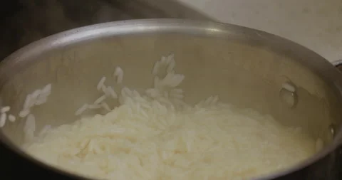Putting a lid on a pot of rice Stock Footage 130688487