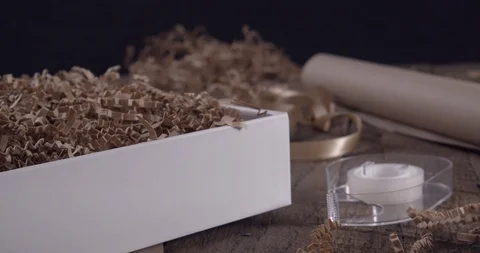 Putting the Lid on a White Gift Box with a Neutral Background Stock Footage 125880843