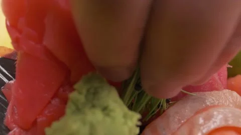 Putting lime on sushi with daikon, lemon slices Stock Footage 213469550