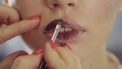 Putting on a lipstick with a special brush Video stock 84590445