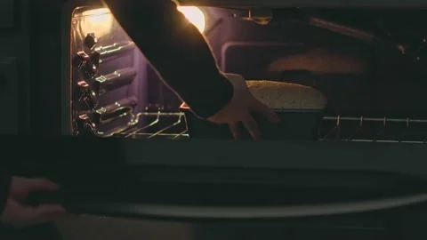 Putting Loaf Of Bread Into Oven To Bake Stock Footage 149167321